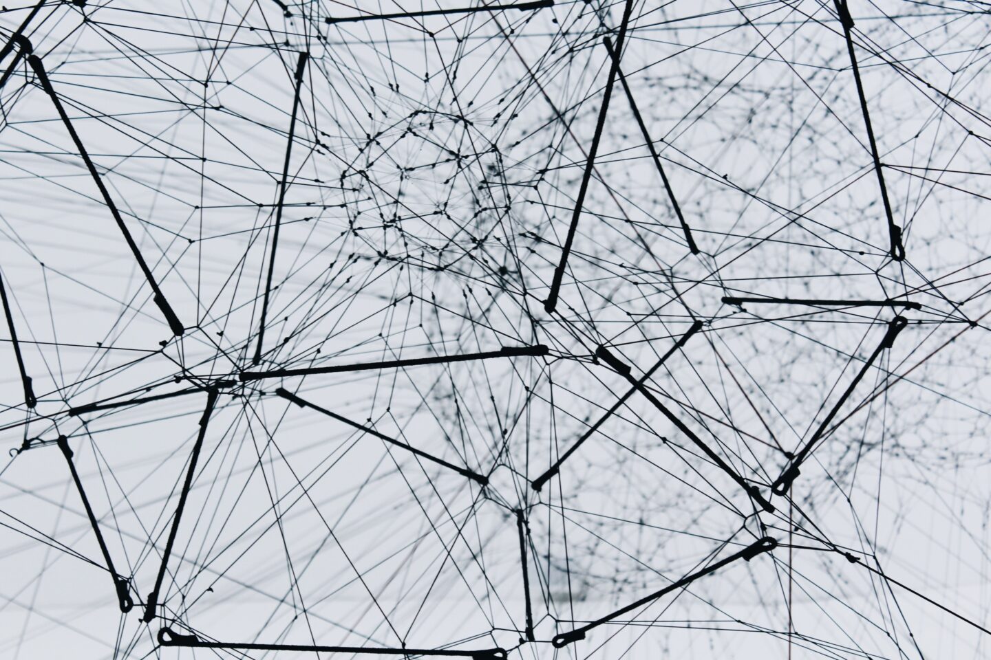 A network of black wires, making a hexagonal, interlinked shape. 