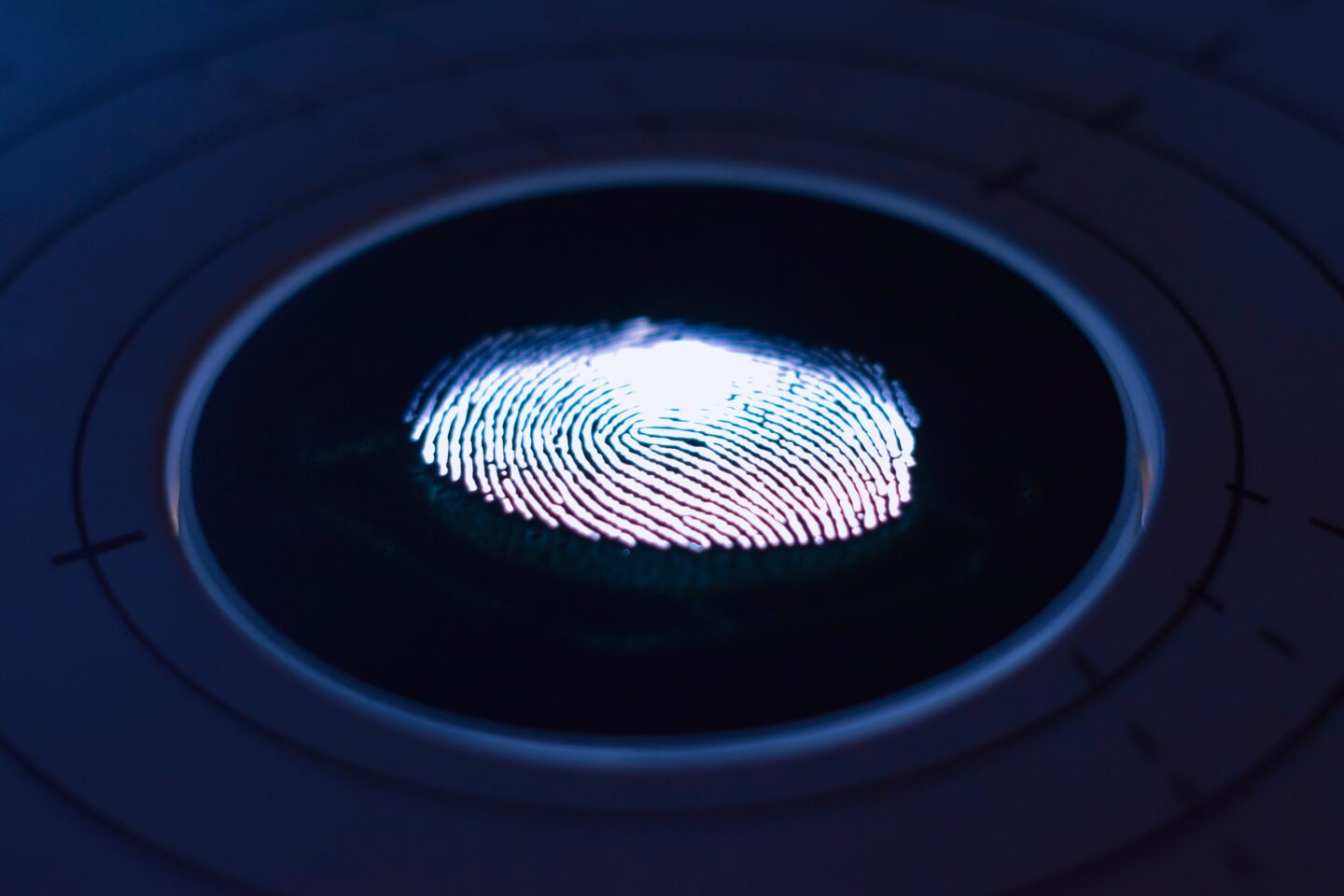 A glowing finger print on a black background. 